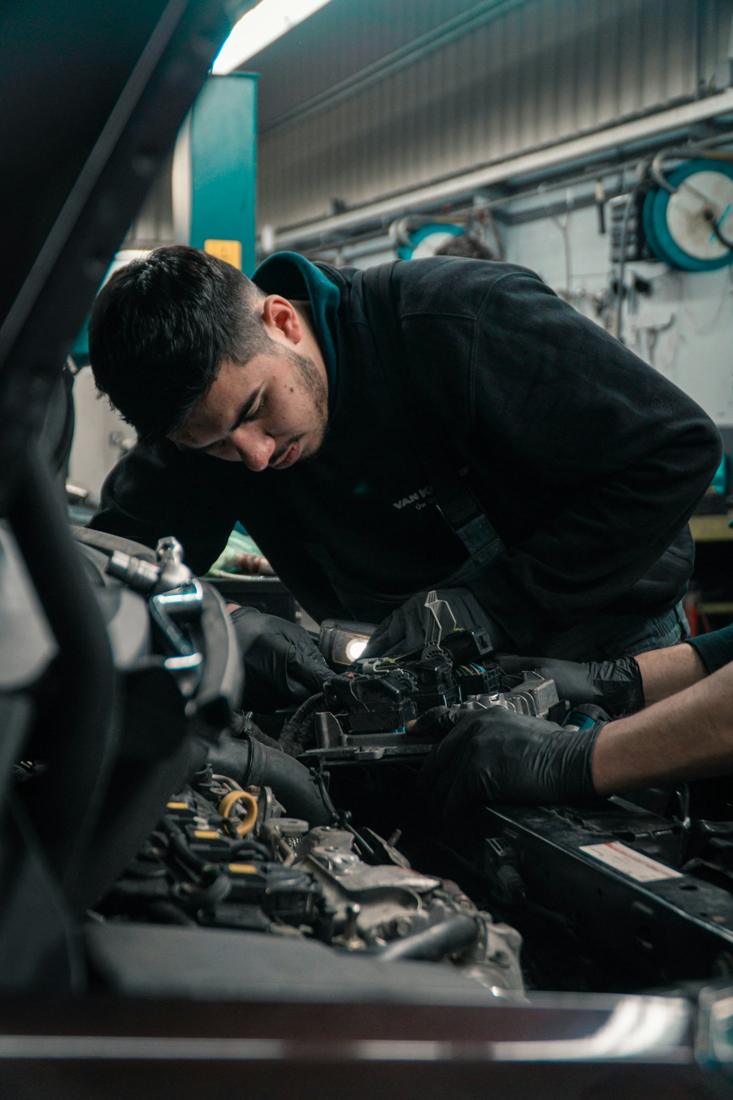 Technician leaning into an engine bay