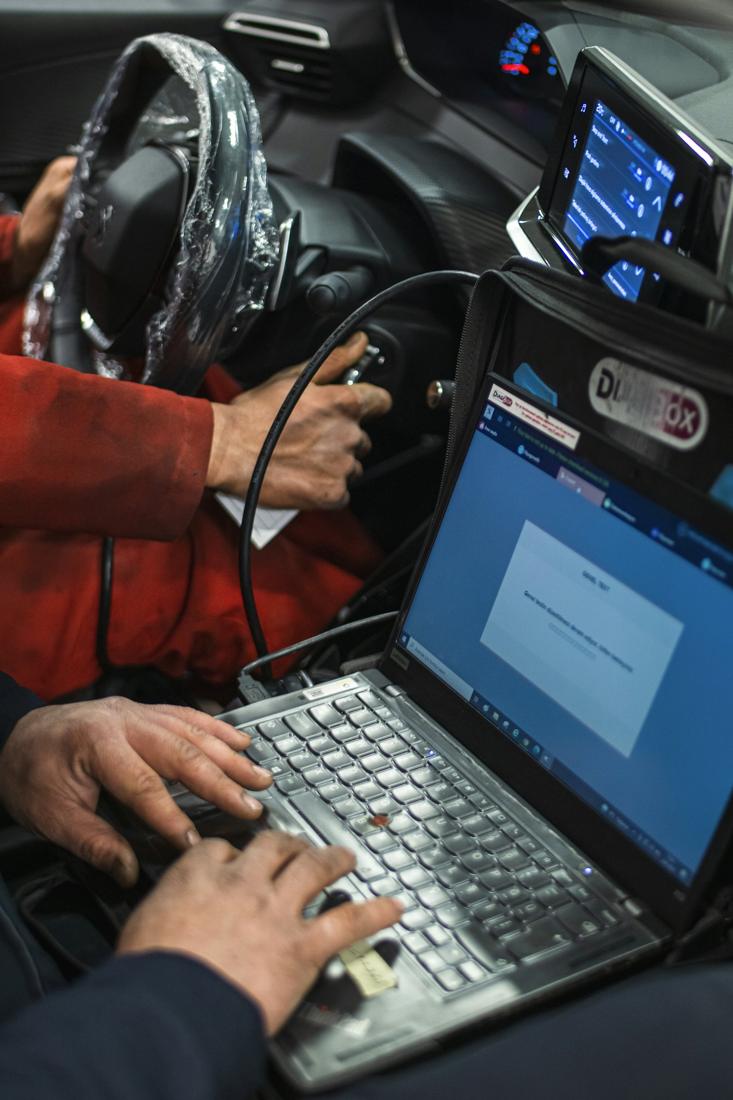 Technician running a hybrid diagnostic on a laptop