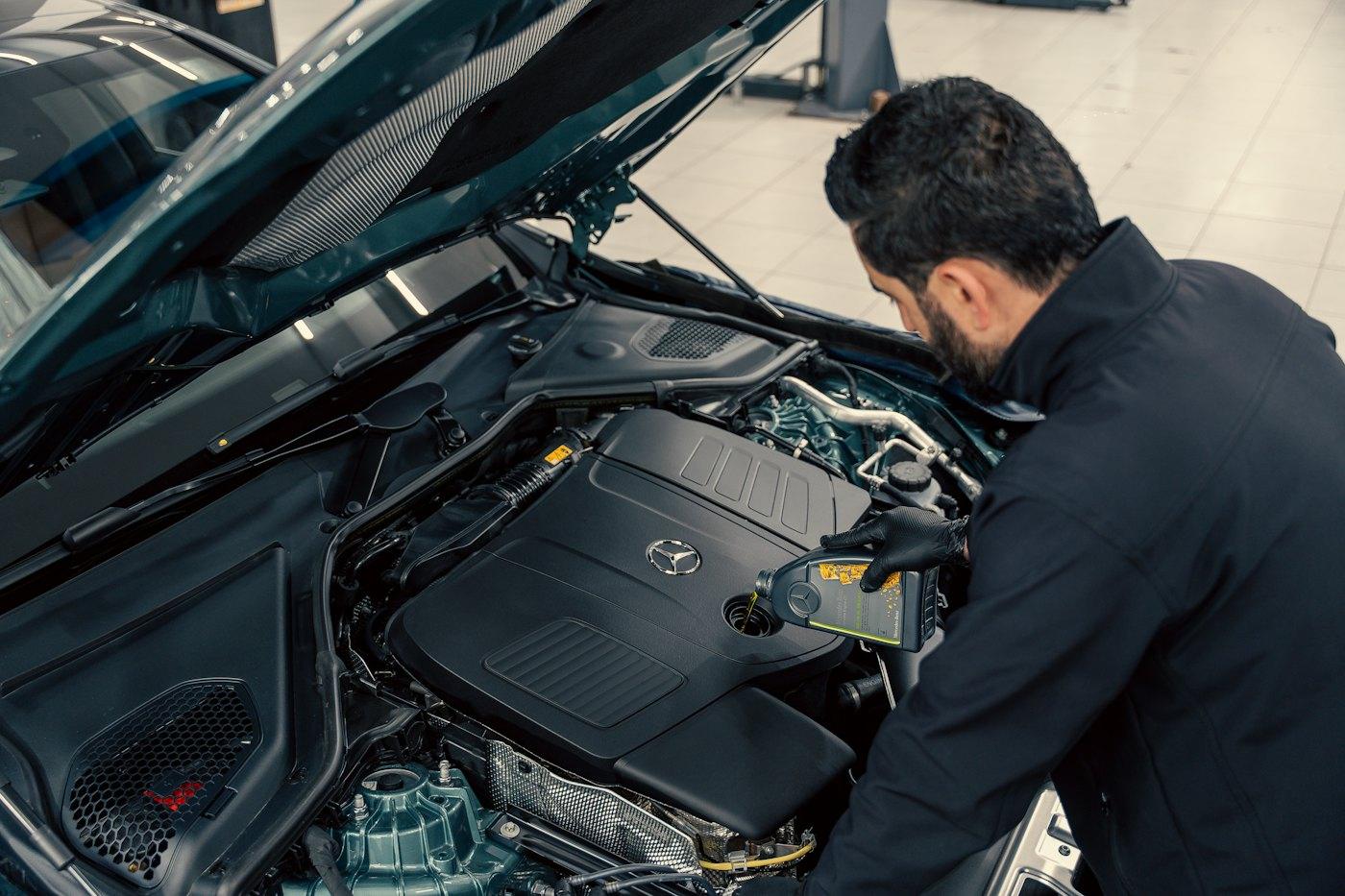 Technician inspecting an engine bay